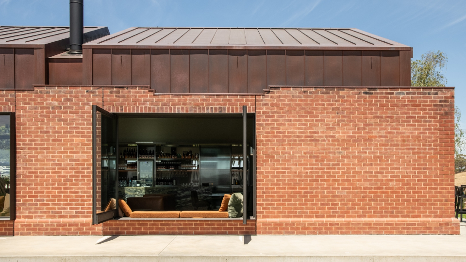 Vinteloper's red-bricked building with its doors opening showing a bar area inside.